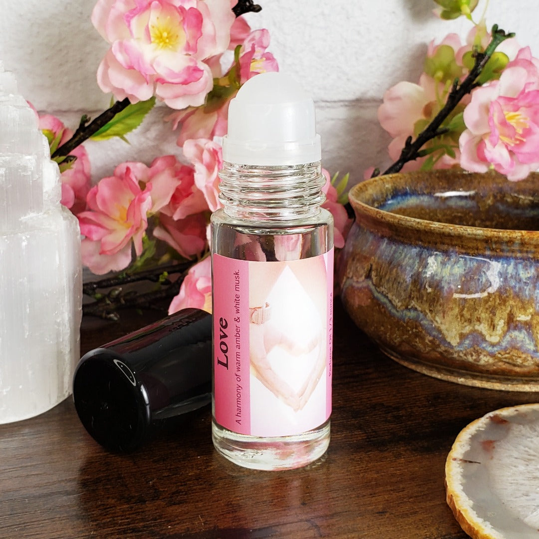 love perfume oil, a blend of white musk and soothing amber fragrances, showing the roller ball for the large one ounce bottle