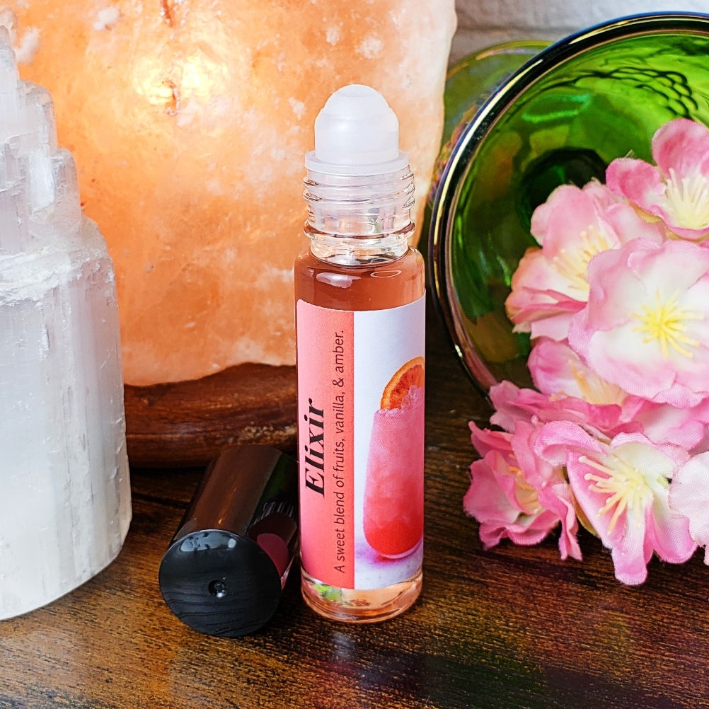 Roll-on perfume bottle labeled 'Elixir' with a pink label featuring a fruit illustration