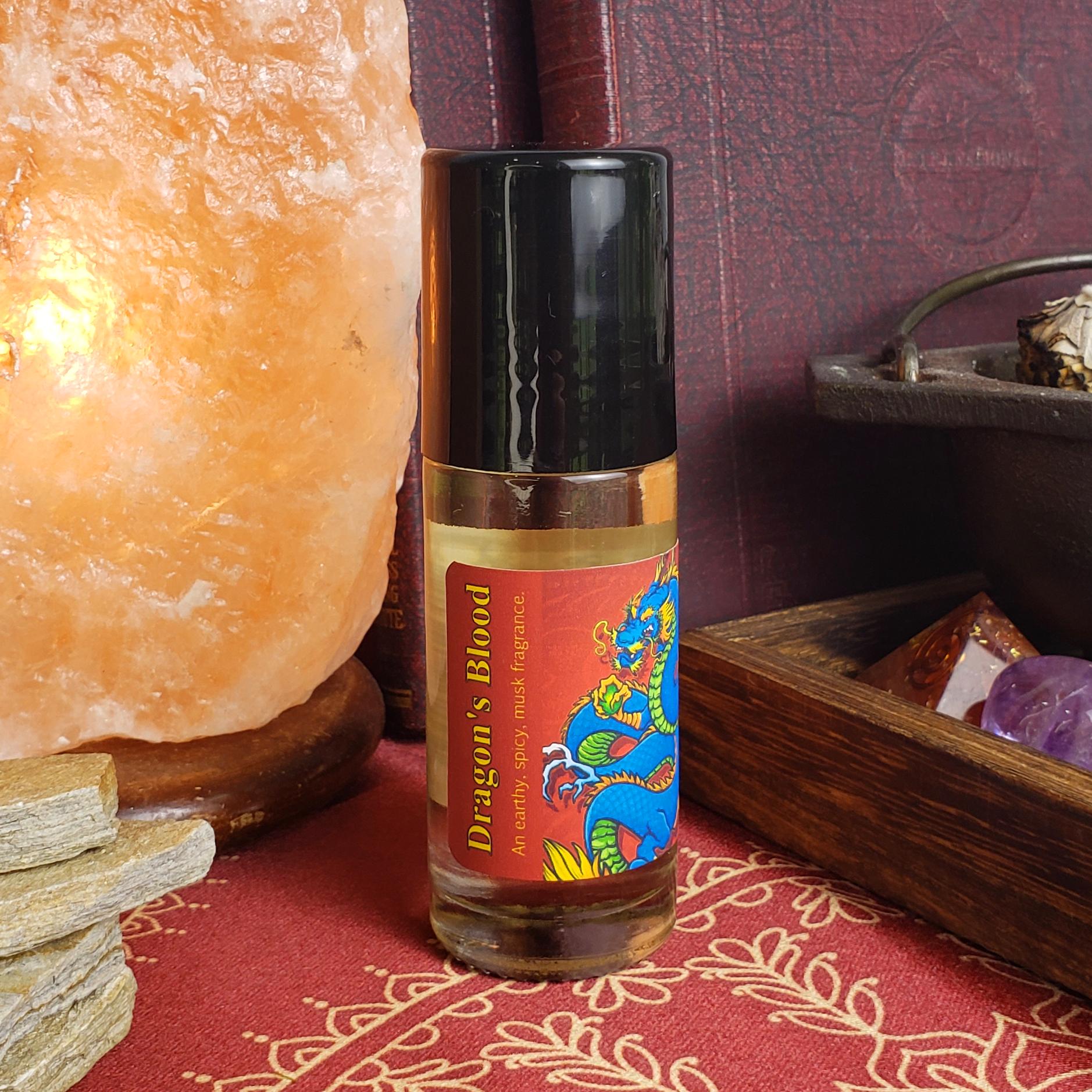 larger one ounce bottle of dragon's blood perfume oil showing the black cap covering the rollerball