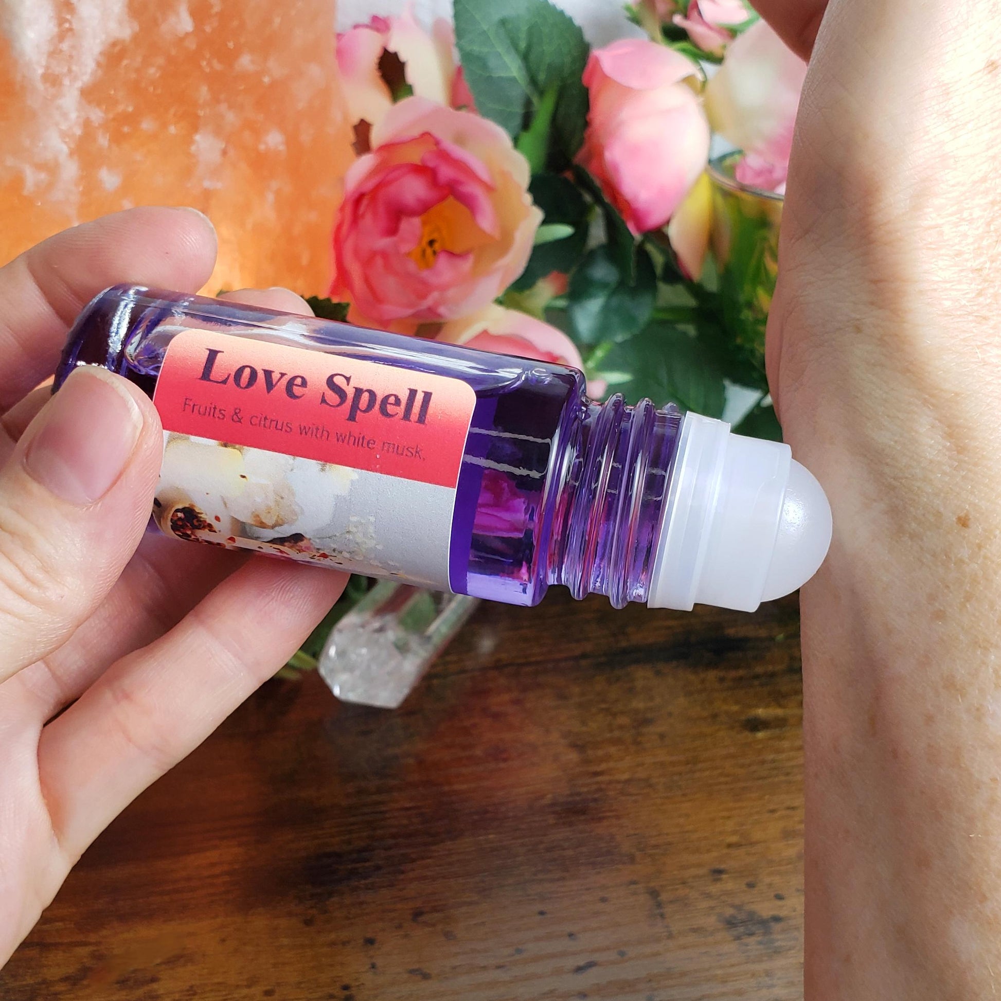 Showing how to apply Love Spell perfume oil to the wrist using the rollerball, perfume by Shadow Scents