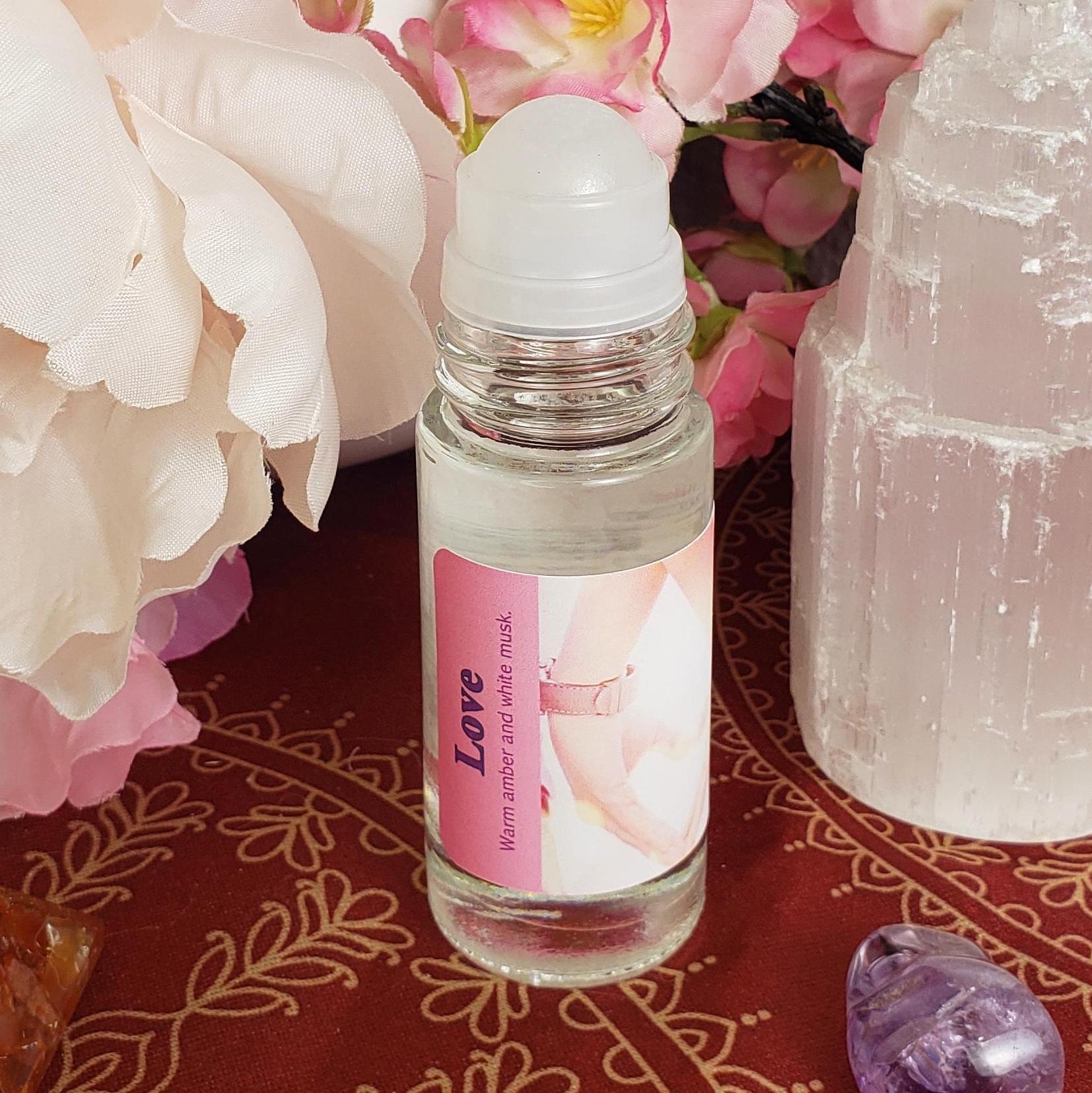 The large 1 ounce bottle of Love perfume oil, warm amber and white musk, showing the rollerball feature