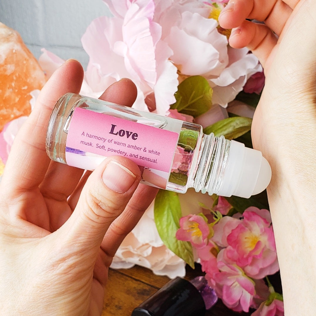 love perfume oil being applied to the wrist