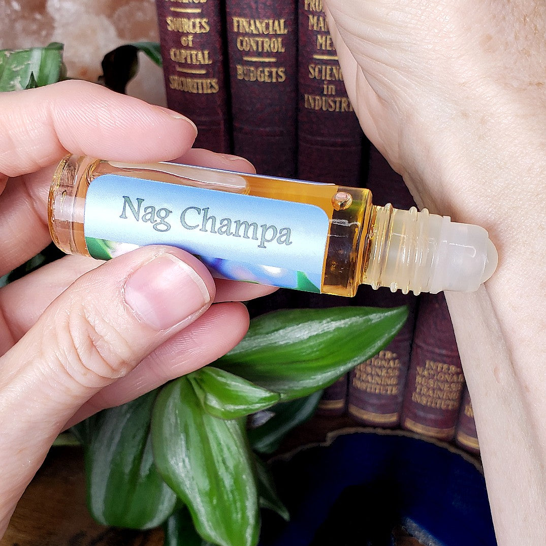 applying nag champa perfume oil to wrist