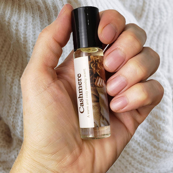 Cashmere Perfume Oil in hand on background